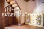 Charming wooden staircase and built-in storage add character to this home.