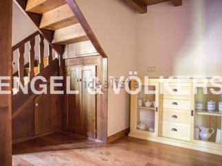 Charming wooden staircase and built-in storage add character to this home.