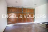 Spacious garage with wooden doors, offering ample storage space.