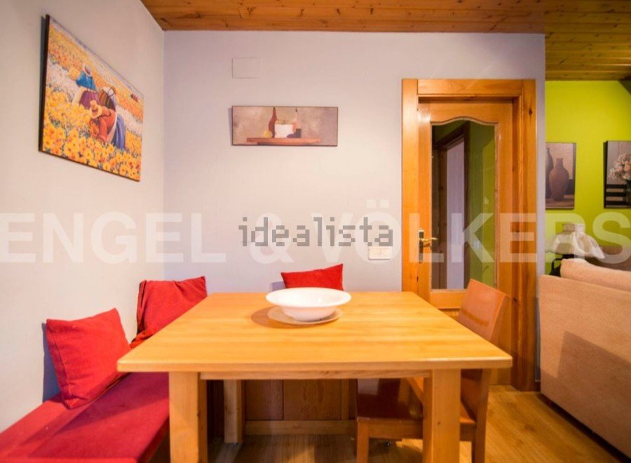 Cozy dining area with built-in bench seating and wooden table.
