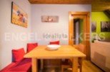 Cozy dining area with built-in bench seating and wooden table.