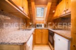 Cozy chalet kitchen with granite countertops and wooden cabinetry.