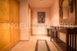 This charming hallway boasts a built-in wooden wardrobe, offering ample storage space.