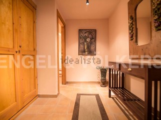 This charming hallway boasts a built-in wooden wardrobe, offering ample storage space.