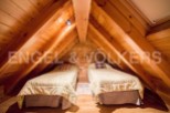 Cozy attic bedroom with twin beds, perfect for a relaxing getaway.