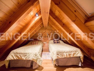 Cozy attic bedroom with twin beds, perfect for a relaxing getaway.