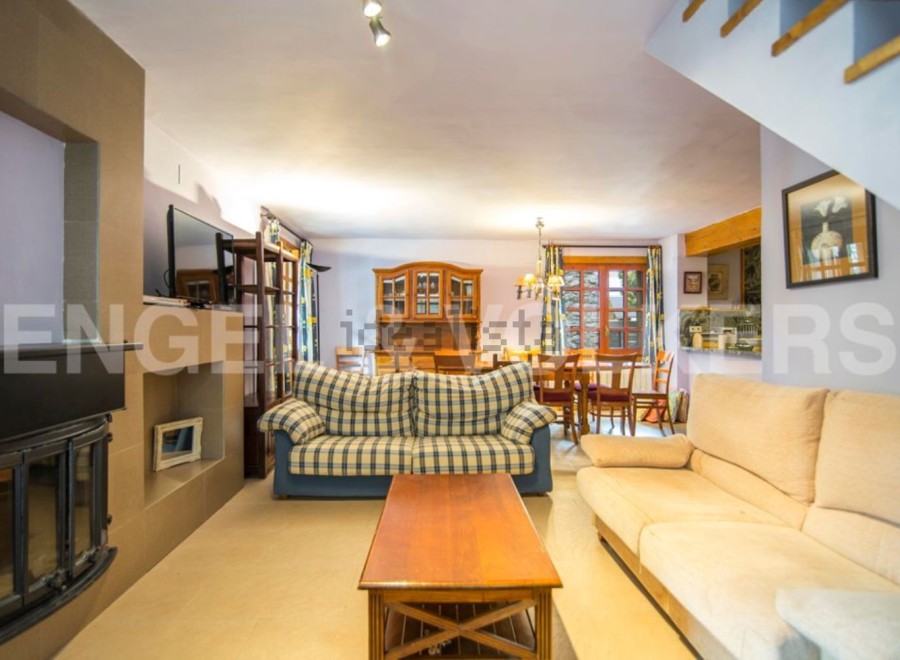 Cozy living room with fireplace and comfortable sofas, perfect for relaxing after a day of exploring.