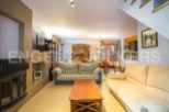 Cozy living room with fireplace and comfortable sofas, perfect for relaxing after a day of exploring.