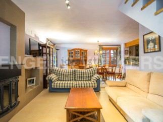 Cozy living room with fireplace and comfortable sofas, perfect for relaxing after a day of exploring.