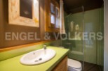 Charming bathroom with a green countertop and a walk-in shower.