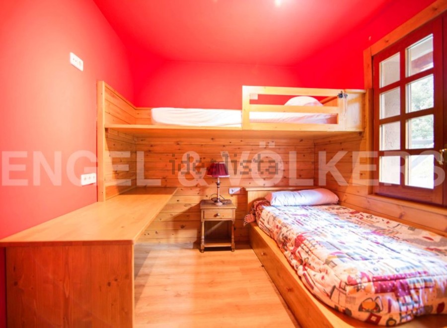 Cozy bunk bed room with built-in desk and window seat.