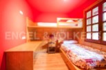 Cozy bunk bed room with built-in desk and window seat.