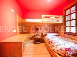 Cozy bunk bed room with built-in desk and window seat.