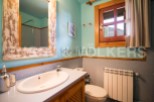 Charming bathroom with rustic wooden accents and a light blue color scheme.