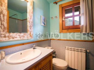 Charming bathroom with rustic wooden accents and a light blue color scheme.