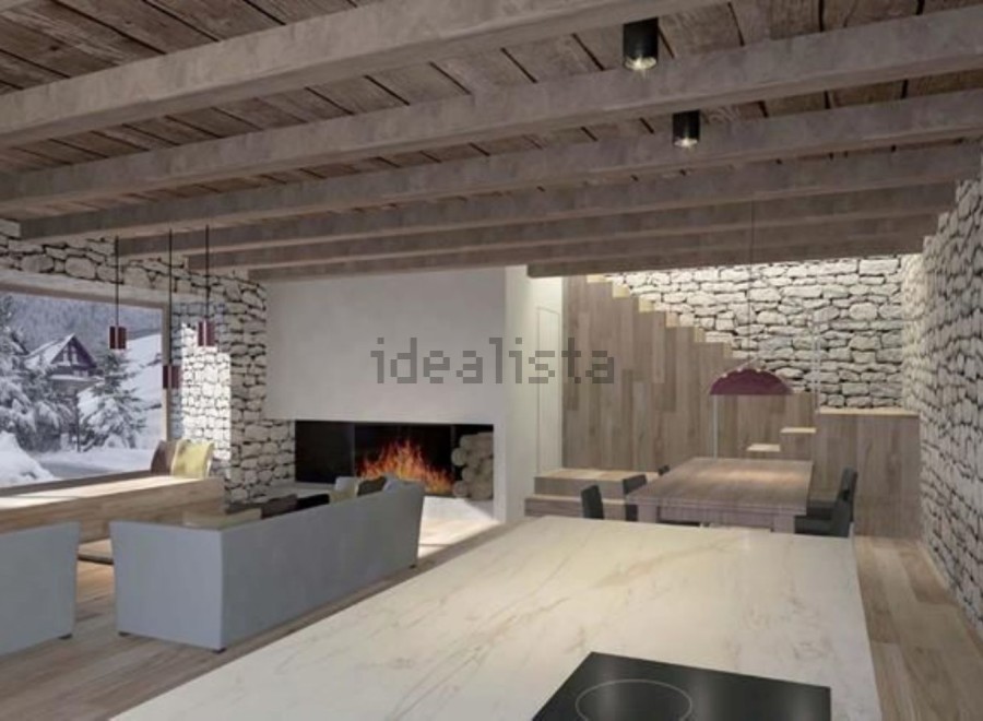 This stunning chalet boasts a spacious open-plan living area with exposed wooden beams and a cozy fireplace, creating a warm and inviting atmosphere.