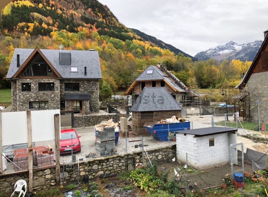 Mountainside home under construction with stunning fall foliage views.