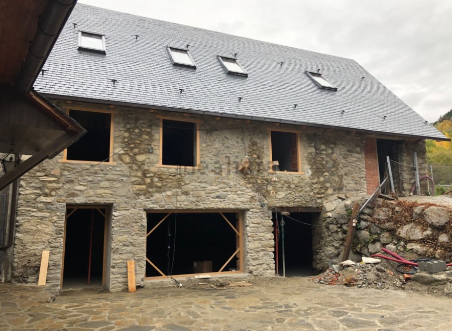 This stunning stone house boasts a newly installed slate roof, complementing its rustic charm.