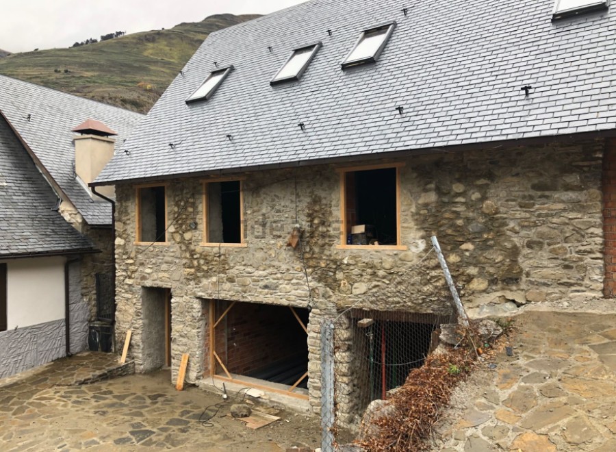 This stunning stone house boasts a newly renovated slate roof, featuring multiple skylights for ample natural light.