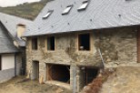 This stunning stone house boasts a newly renovated slate roof, featuring multiple skylights for ample natural light.