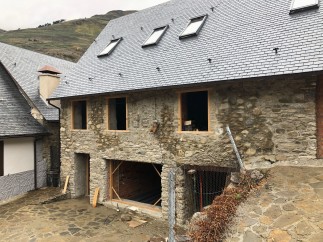 This stunning stone house boasts a newly renovated slate roof, featuring multiple skylights for ample natural light.