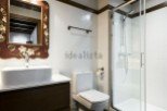 Charming bathroom with a vintage-style mirror and modern fixtures.