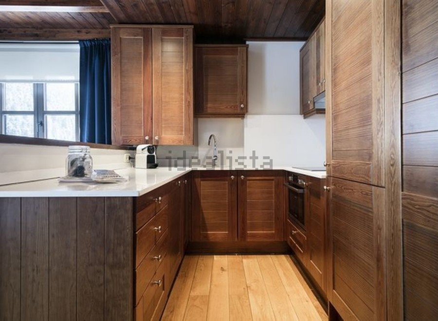 This stunning kitchen boasts rich, dark wood cabinetry, creating a warm and inviting atmosphere.