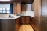 This stunning kitchen boasts rich, dark wood cabinetry, creating a warm and inviting atmosphere.