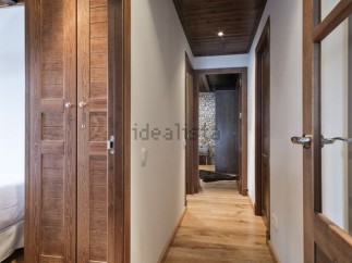 This stunning hallway boasts rich wooden flooring and doors, creating a warm and inviting atmosphere.