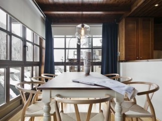 This stunning property boasts a spacious dining area with large windows offering breathtaking views.