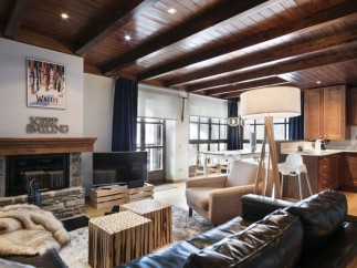 This stunning chalet boasts a spacious open-plan living area with a cozy fireplace, perfect for relaxing after a day on the slopes.