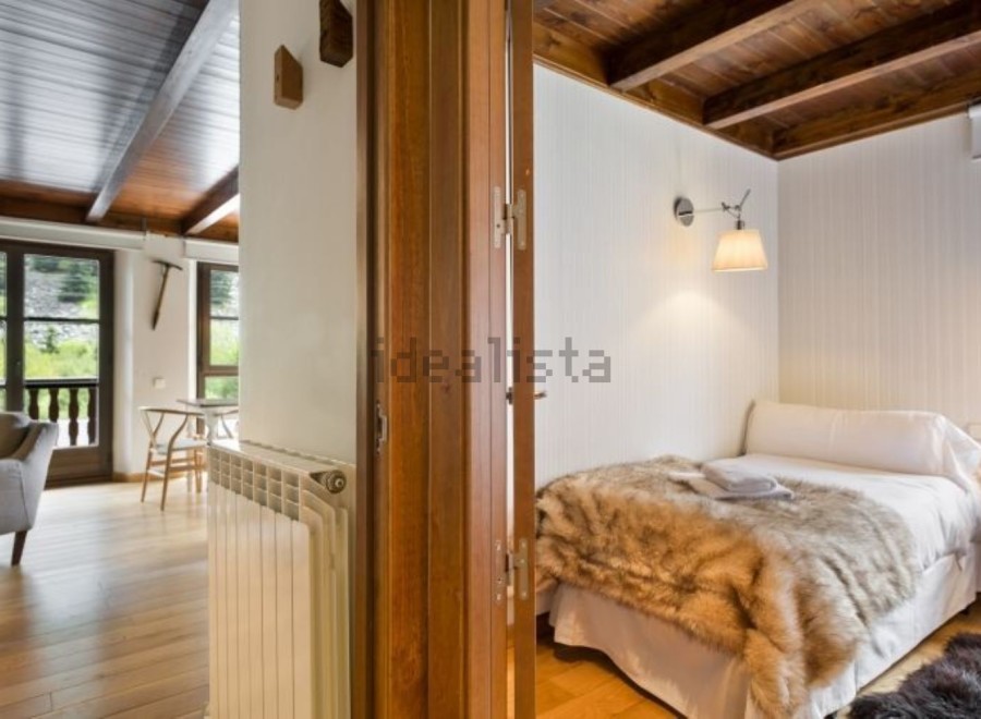 Cozy mountain cabin with rustic wood details and a comfortable bedroom.