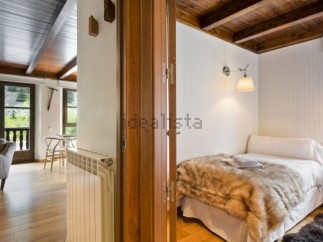 Cozy mountain cabin with rustic wood details and a comfortable bedroom.