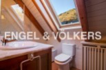 Charming attic bathroom with skylight offering mountain views.