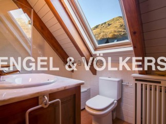 Charming attic bathroom with skylight offering mountain views.