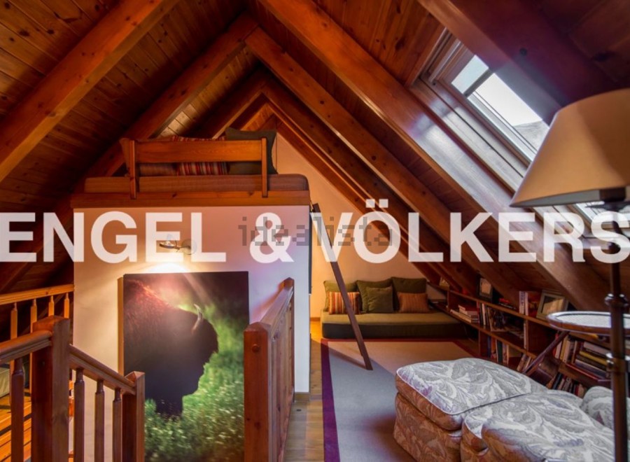 Charming attic retreat with wood-beamed ceilings and skylights.