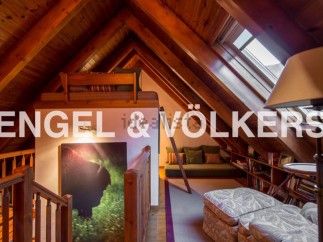 Charming attic retreat with wood-beamed ceilings and skylights.