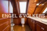 This stunning bathroom boasts a unique wooden design, complete with skylights that flood the space with natural light.