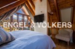 This stunning chalet boasts a spacious bedroom with breathtaking mountain views, creating a serene and relaxing atmosphere.