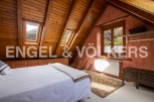 Cosy attic bedroom with wooden beams and mountain views.