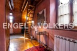 Charming attic room with wooden beams, exposed brick walls, and a cozy atmosphere.