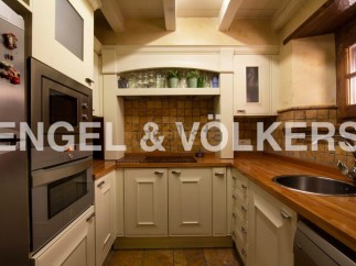 Charming kitchen with rustic wooden beams and tiled backsplash.