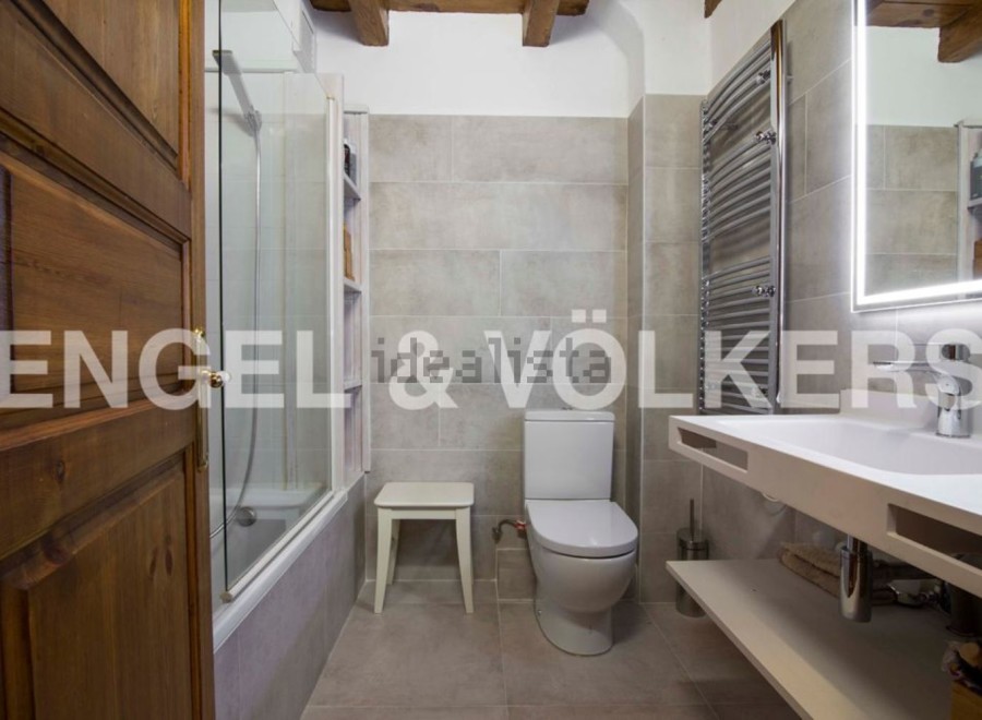 This stunning bathroom boasts a modern design with sleek white fixtures and a spacious shower.