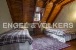 Charming attic bedroom with twin beds, wooden beams, and a cozy atmosphere.