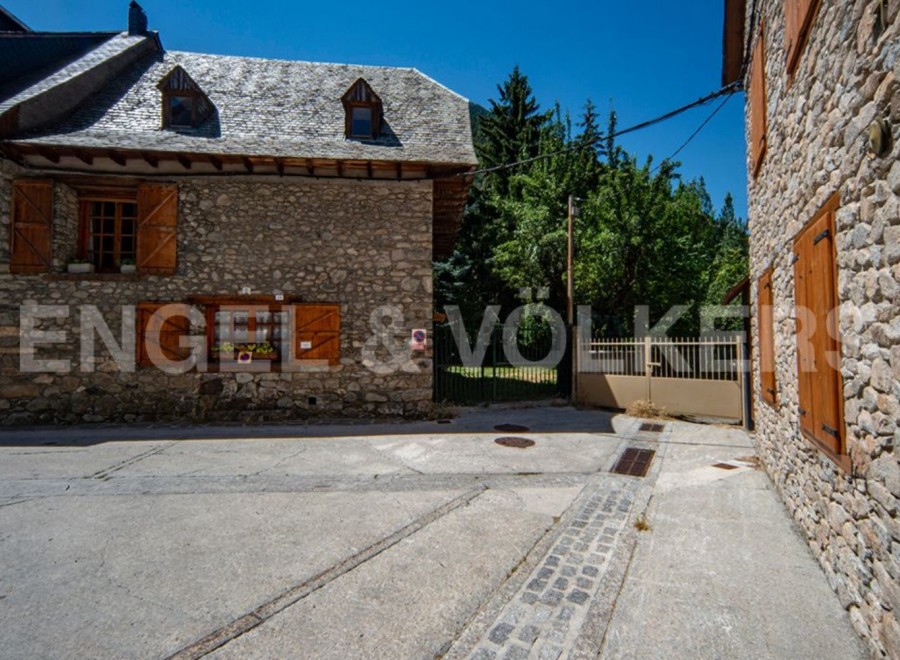 Charming stone house nestled in a serene mountain setting.