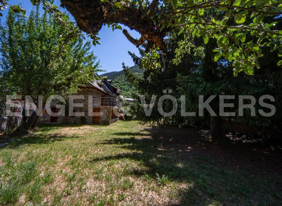 Discover this charming stone house nestled in a serene mountain setting.