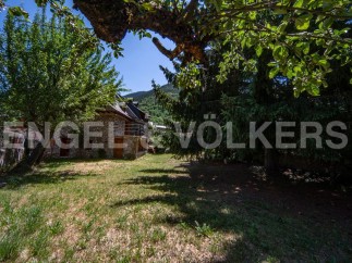 Discover this charming stone house nestled in a serene mountain setting.