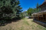 Mountain view home with large backyard and stone exterior.
