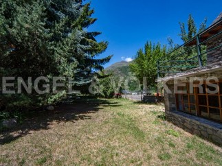 Mountain view home with large backyard and stone exterior.