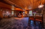 Rustic mountain home with stone fireplace and wood-beamed ceilings.